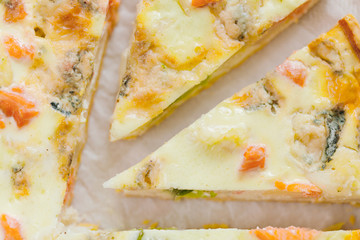 smoked salmon, Brussels sprouts and gorgonzola quiche tart, top view. Piece of homemade pie