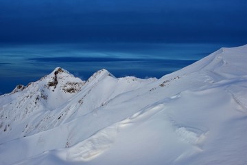 snowy mountains in winter season on sunny day at high altitude