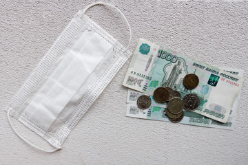 protective mask and money on a white background