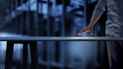 Business man pushing on a touch screen interface with table counter futuristic computer.