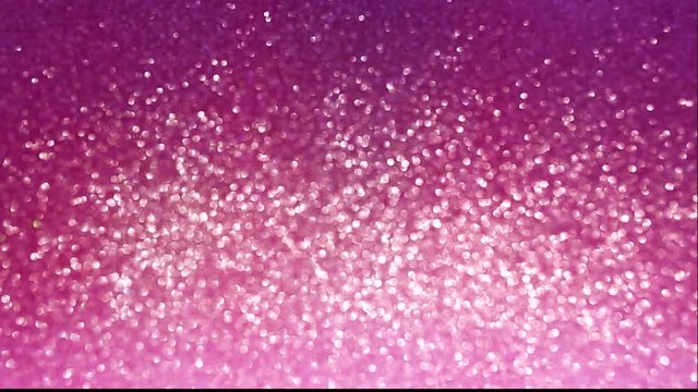 Pink glitter background with sparkling texture. Beautiful pink shimmering light.