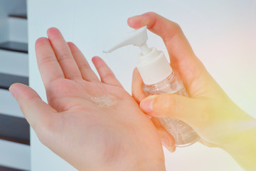 Woman hands using gel alcohol sanitizer cleaning her hands, to prevent the virus and bacterias, she protects herself and her family from viruses and bacterias. Hygiene concept.Close up.