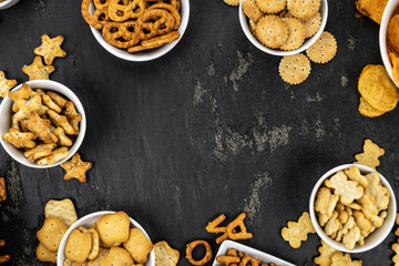 Mixed Snacks on dark background (close up shot; selective focus)