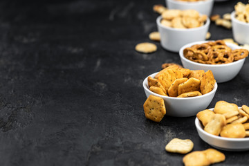 Mixed Snacks on dark background (close up shot; selective focus)