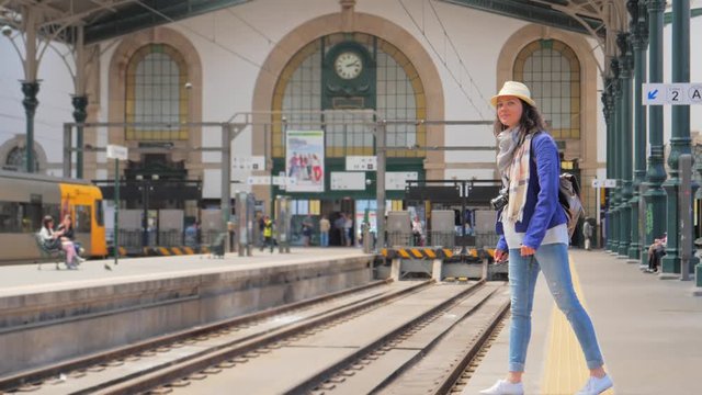 Woman passenger waiting for a train on railway station