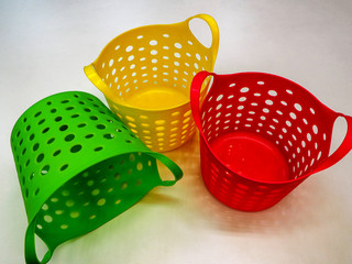 three colorful plastic baskets close up