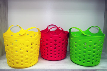 three colorful plastic baskets close up