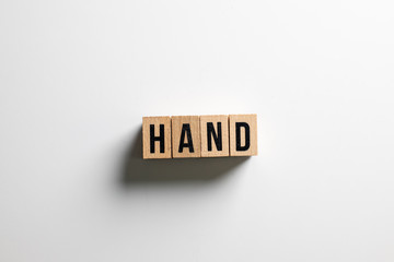 " hand " text made of wooden cube on  White background.