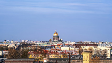 Fototapeta na wymiar Urban panoramic landscape. View of the old city over the roofs. Saint Petersburg is a city on the Neva river.