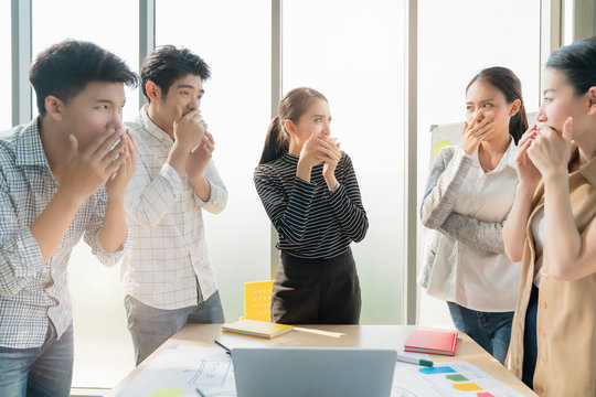 business team meeting people hand hold mouth shut becareful of bad mouth spread bad smell mouth problem in public area