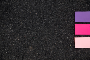 Fototapeta premium Three varieties of fitness gum for sport on black background