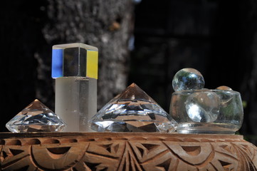 Light, shadow, reflection and color effects in glass objects located in a wooden bowl, shadow, reflection and color effects in glass objects located in a wooden bowl