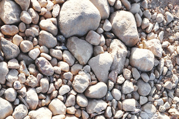 The word CRISIS in paper letters on the background of stones. Crisis concept.