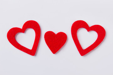 Obraz na płótnie Canvas Three flat red hearts with fibre surface. Isolated on white background.