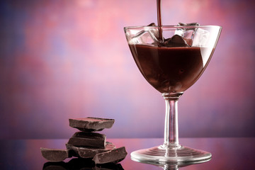 glass of coffee liqueur with ice cubes