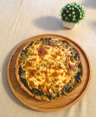 spinach quiche on the table with flower