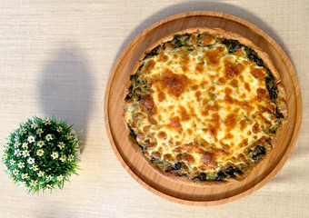 spinach quiche on the table with flower