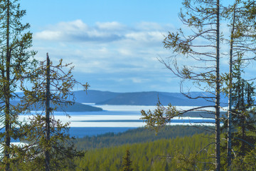 Lake in the forest surrounded by mountains