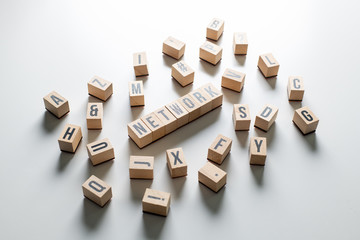 " network " text made of wooden cube on  White background with pile words.