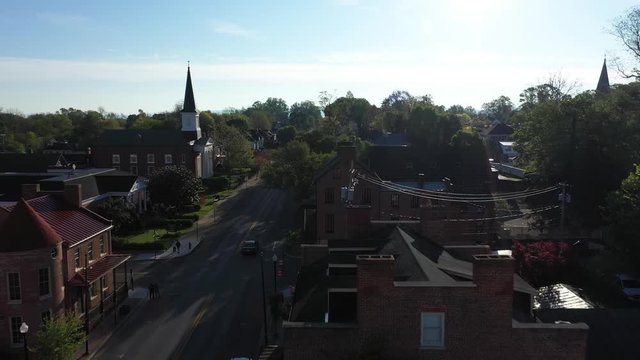 Aerial camera flying low over houses along the mainstream in Charles Town, WV.