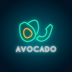 Neon Avocado sign. Glowing avocado fruit emblem on dark background. Stock vector illustration.