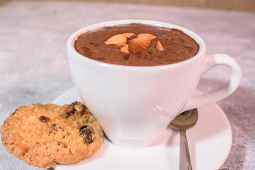 Cramped chocolate with nuts and cookies close-up. Tasty drink.