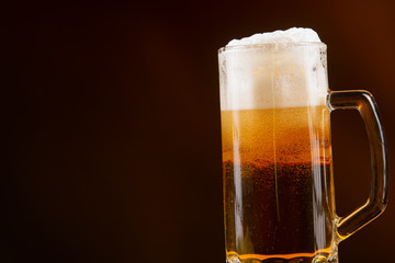 mug of beer on dark background