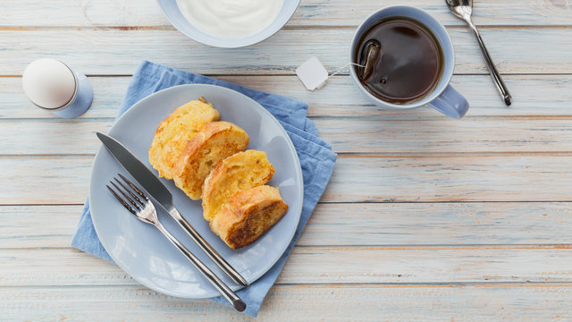 French fried toast with tea, boiled eggs and fresh yogurt. Tasty farmer breakfast.