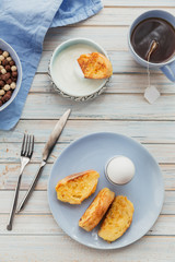 French fried toast with tea, boiled eggs and fresh yogurt. Tasty farmer breakfast.