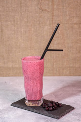 Healthy drink - blackcurrant berry smoothie. Close-up. Drink for vegetarians.