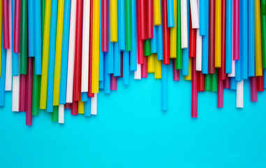 drinking straws for a party on a blue background. template with space for text