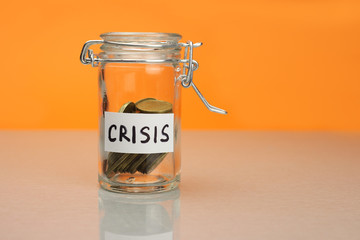 crisis word on piggy Bank, moneybox, money jar with coins