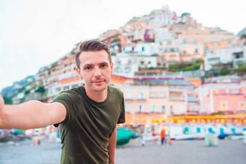 Summer holiday in Italy. Young man in Positano village on the background, Amalfi Coast, Italy