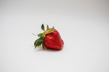One strawberry on a white background with an empty seat.