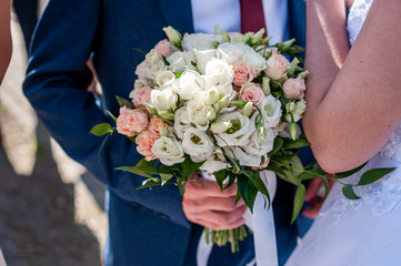 Groom holding colorfull wedding bouquet in the hand