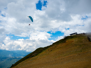 Fototapeta na wymiar landscape, mountain and skydiver in the sky