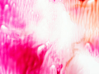 Abstract flowing paint background in pink and red.