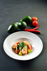 salad with shrimp, vegetables and avocado, diet healthy food, healthy eating concept, black background