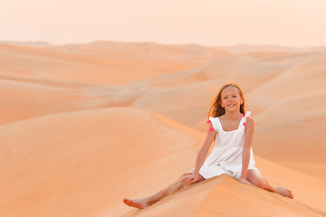 Fototapeta na wymiar Girl among dunes in Rub al-Khali desert in United Arab Emirates