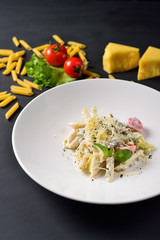 Italian pasta on black background, restaurant menu concept