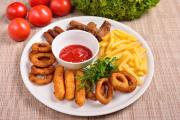 set of beer snacks, fried potatoes, nuggets and sauce