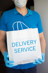 Contactless delivery in mask and disposable gloves of a package with products
