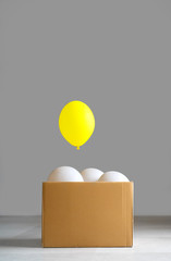 Think outside the box concept. Be different. Be brave. Smart idea. One unique yellow balloon pop up...