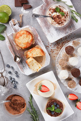 Desserts, proper nutrition. Apple pie, candy, brownie, cheesecake, chocolate mousse with fresh blueberries, strawberries, chocolate and mint on a light background. Flatlay6 top view. Background image