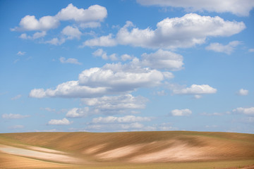 Fototapeta na wymiar An field with beautiful clouds