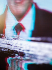 Man in a suit and a tie on the screen. Glitch.