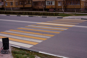 pedestrian crosswalk on asphalt in white and yellow paint