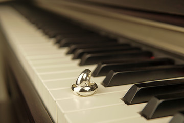 Close-up of piano keyboard with wedding ring