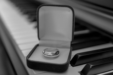 Close-up of piano keyboard with wedding ring