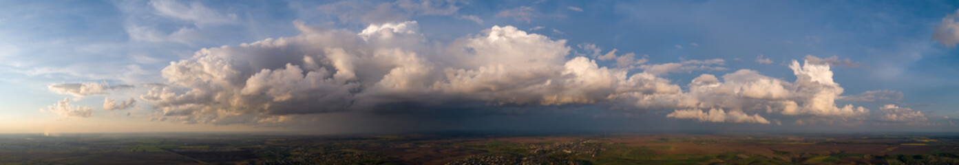 The stormy clouds on sunset panorama